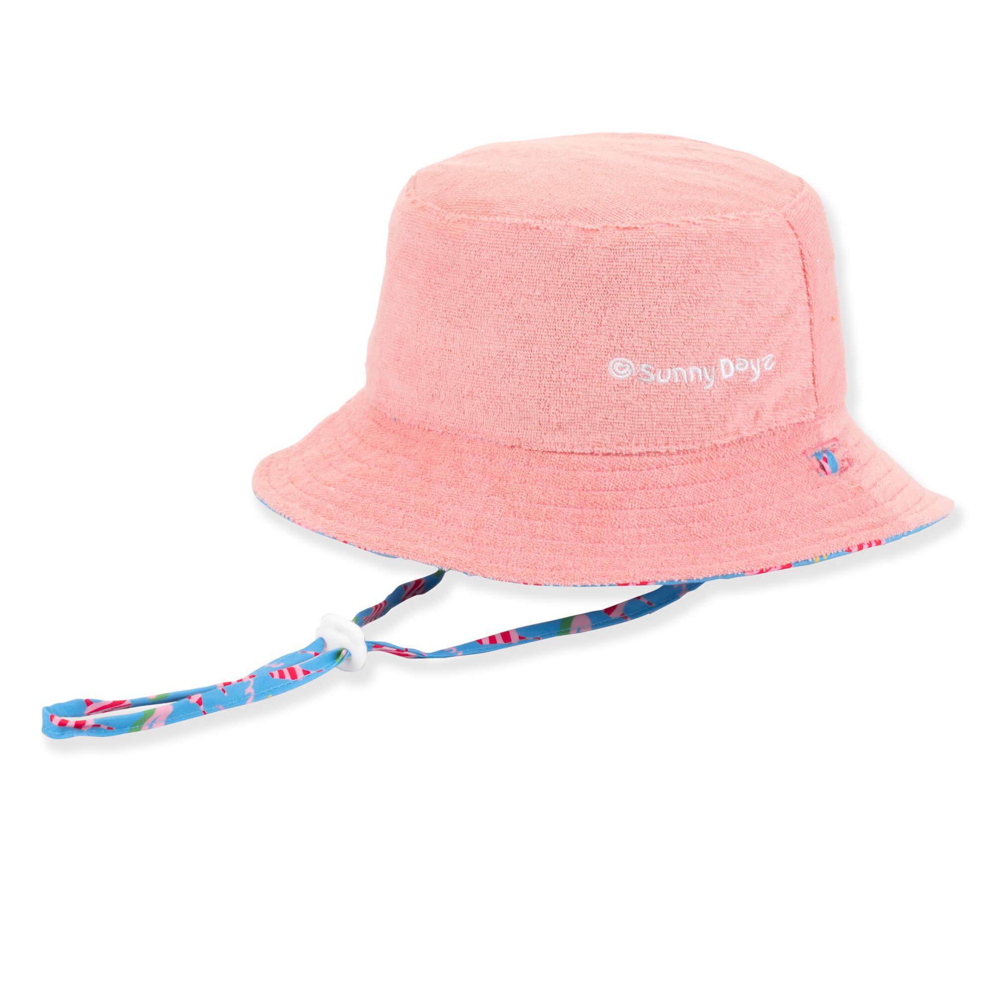 Three-quarter view of a coral terry cloth bucket hat featuring an adjustable patterned chin strap with a white plastic toggle.