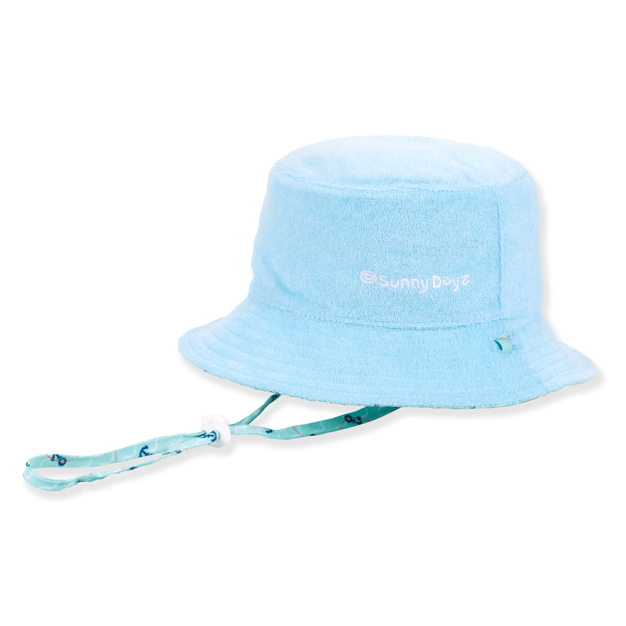 Three-quarter view of a light blue terry cloth bucket hat featuring white embroidered text and an adjustable patterned chin strap.