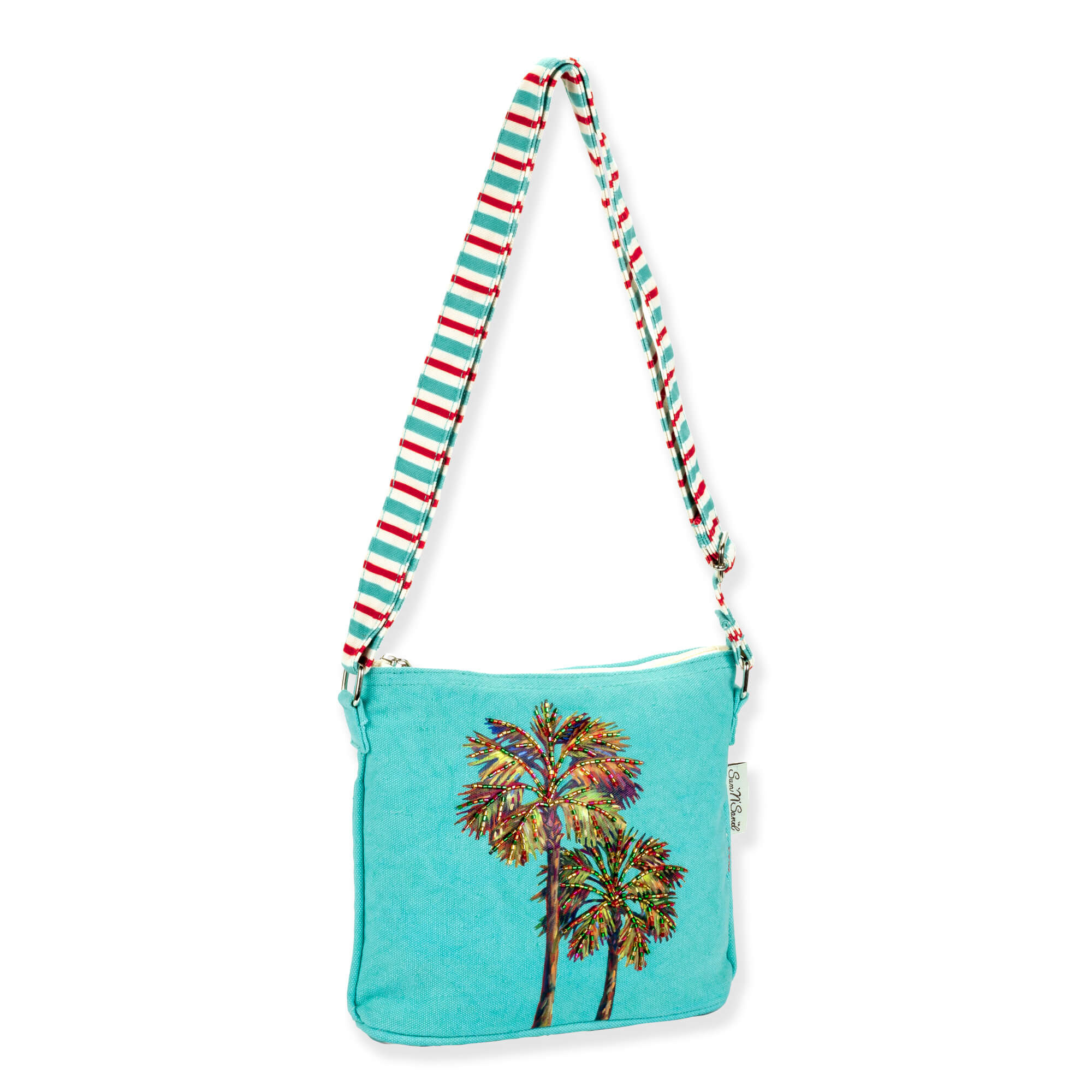 side view of a rectangular turquoise crossbody bag featuring colorful embroidered palm trees, a striped adjustable strap, and metal hardware.