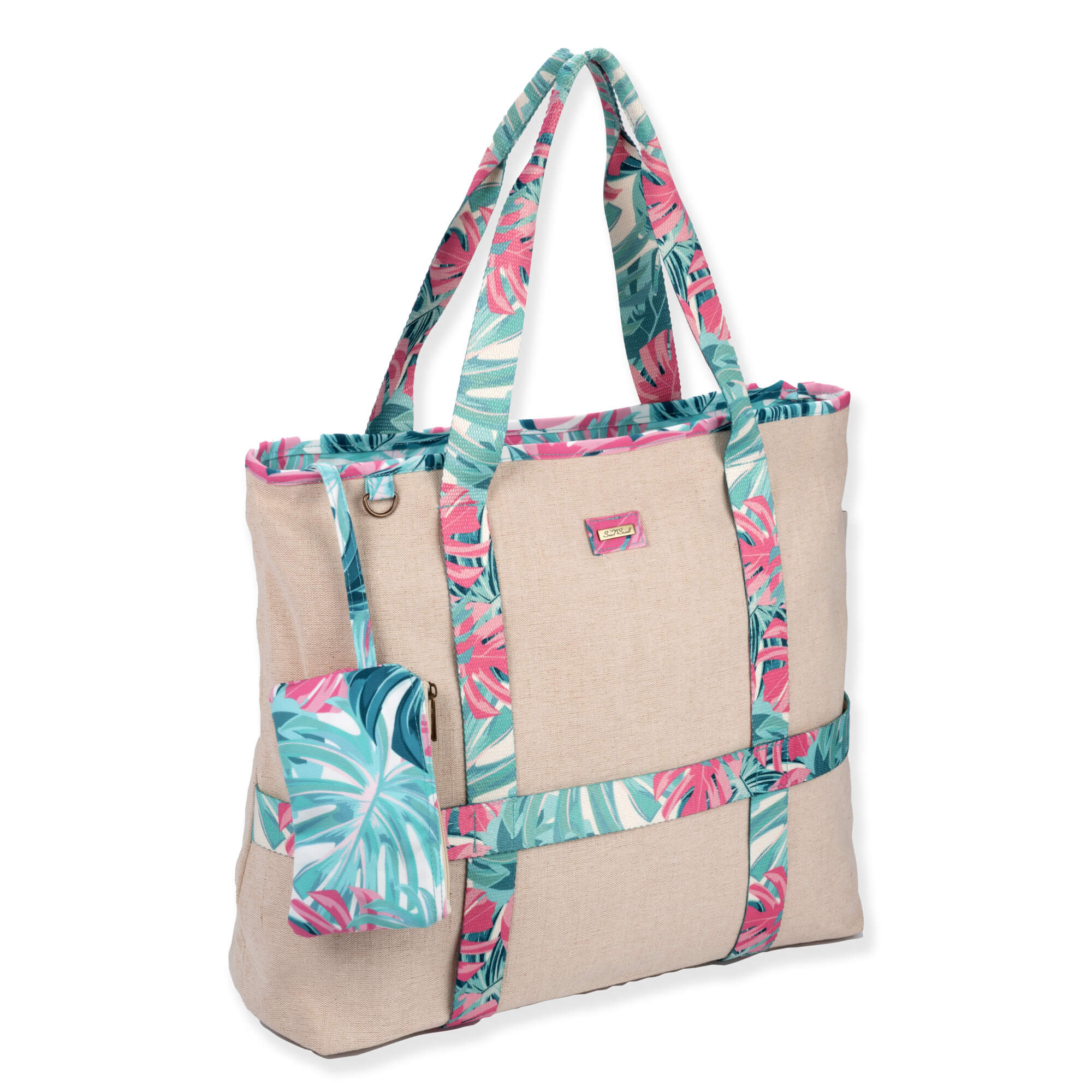 side Front view of a rectangular beige canvas tote bag with pink and green tropical palm print straps and matching accessory pouch.