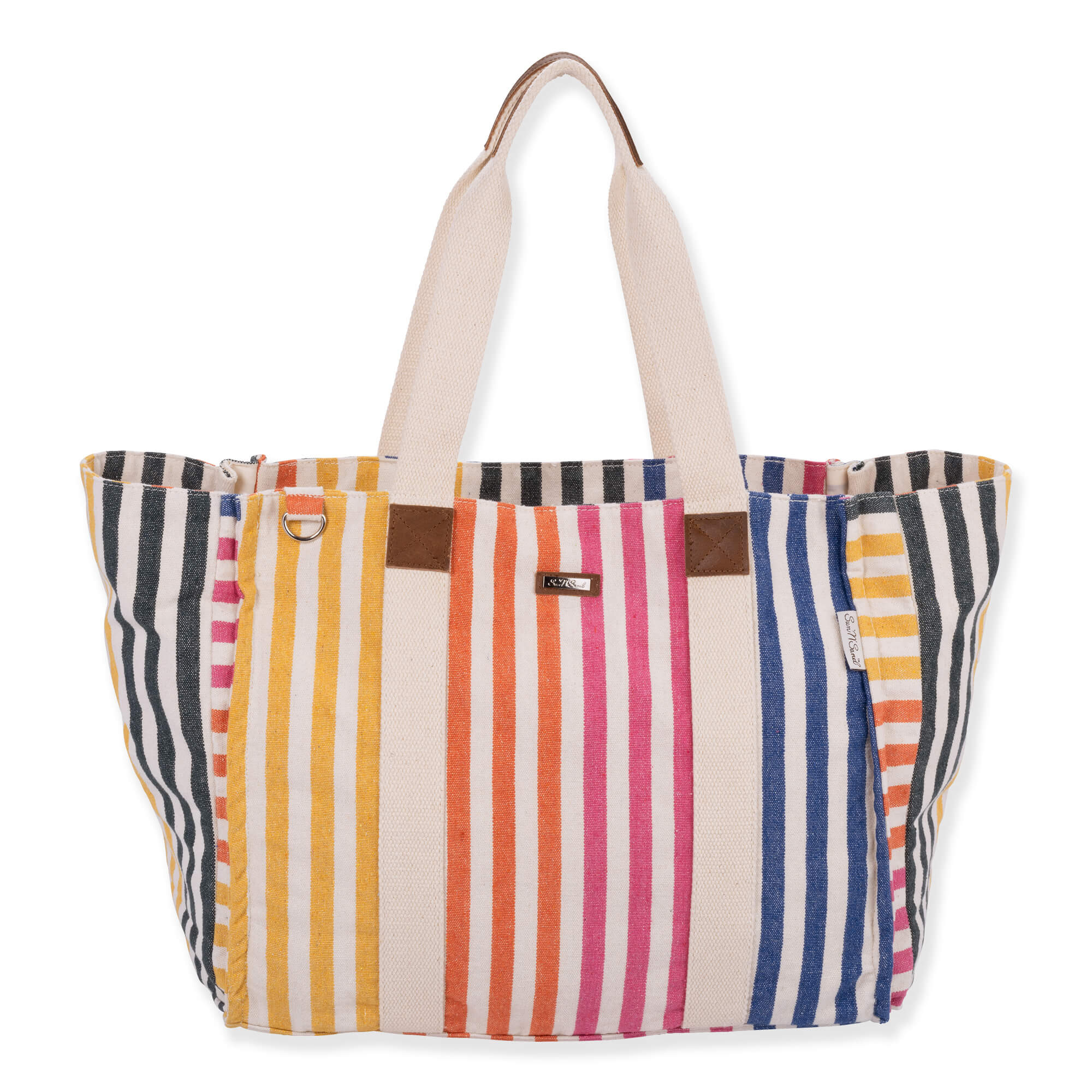 Front view of a rectangular multi-color striped canvas tote bag featuring cream fabric handles, brown leather tabs, and metal hardware.