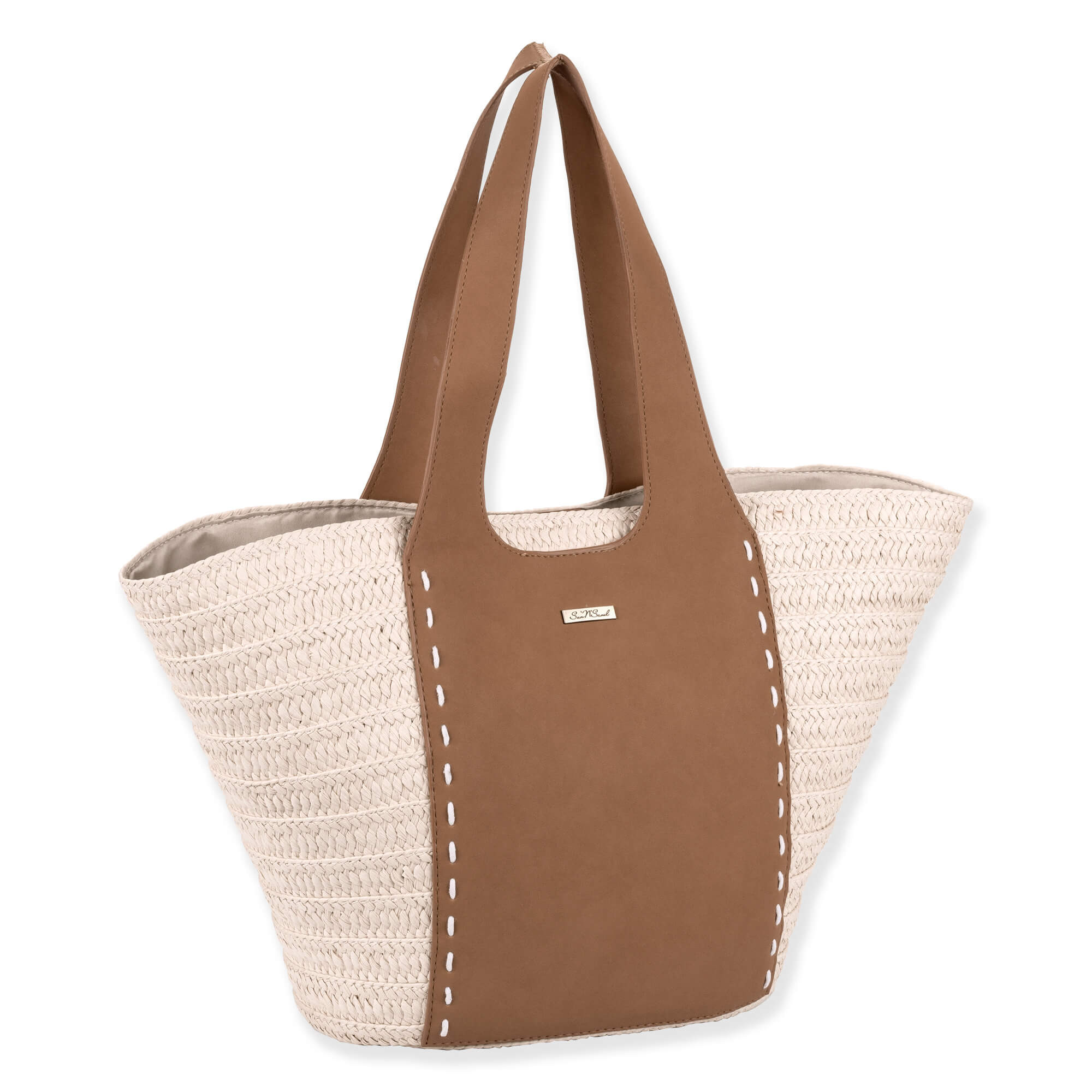 Side view of large woven tote with light straw body, brown leather center panel, stitched handles, and small metallic tag highlighting structured design.