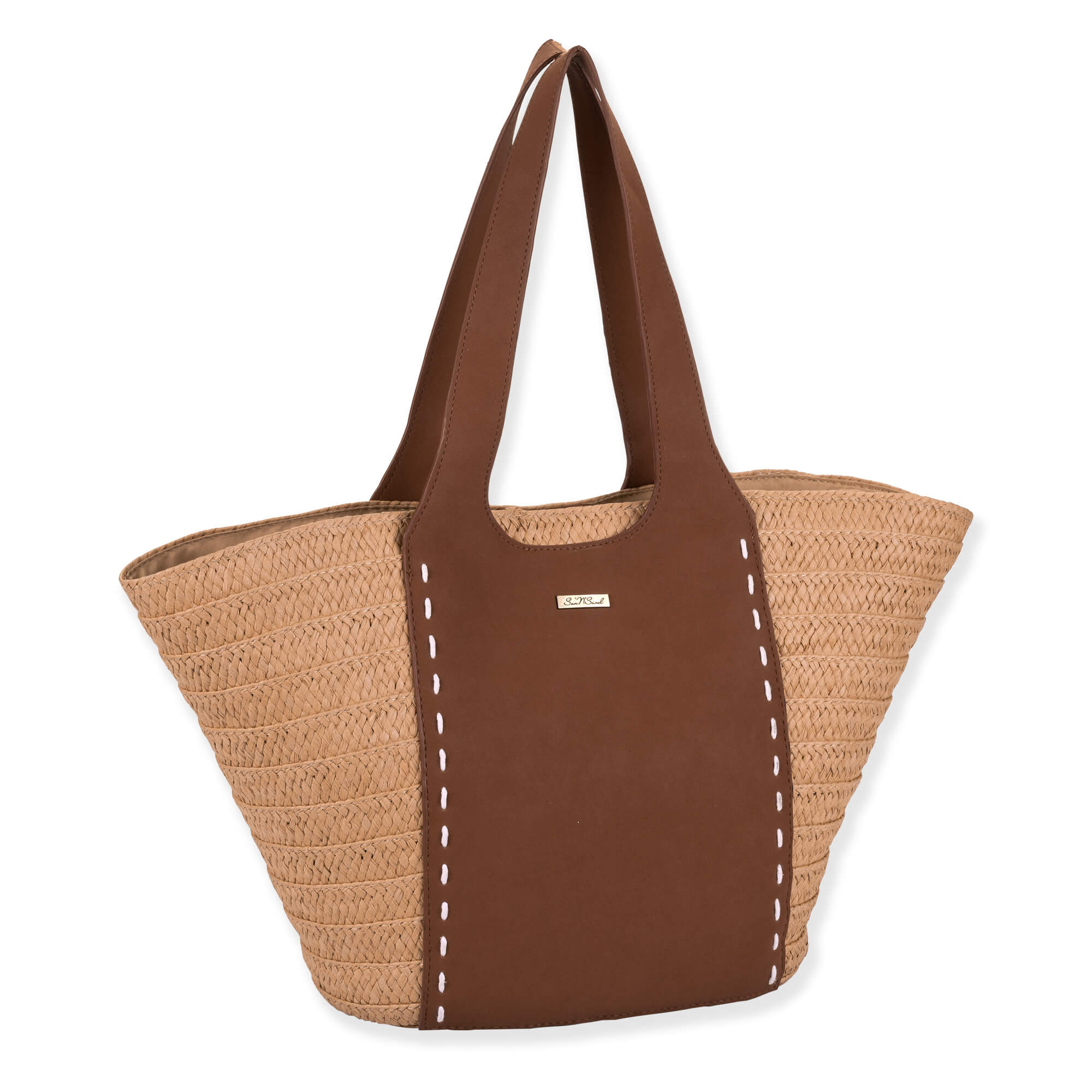 side view of large woven tote with straw side panels, brown leather center section, wide stitched handles, and small metallic logo detailing.