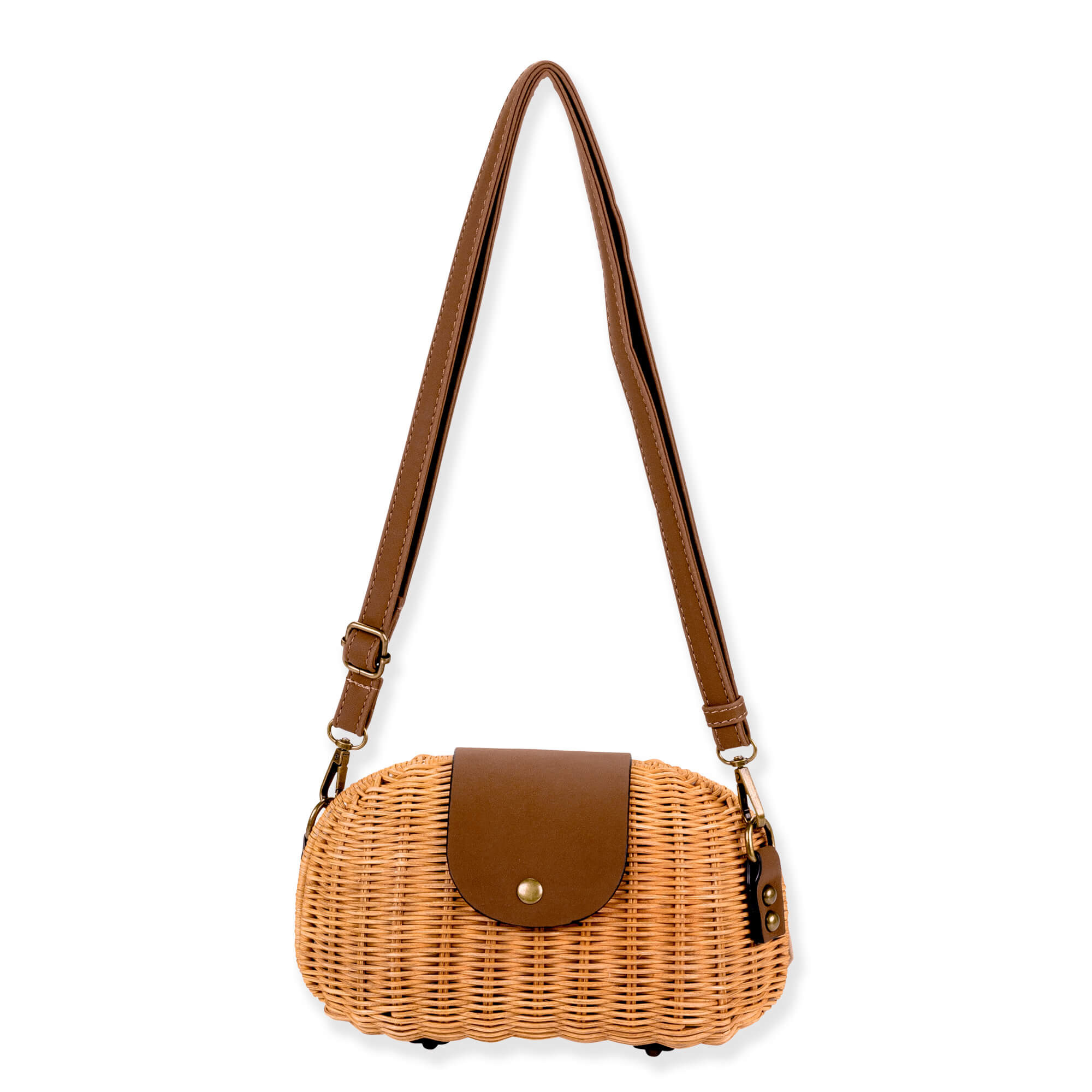 Front view of a brown oblong wicker bag featuring a dark leather snap flap, adjustable shoulder strap, and bronze hardware.