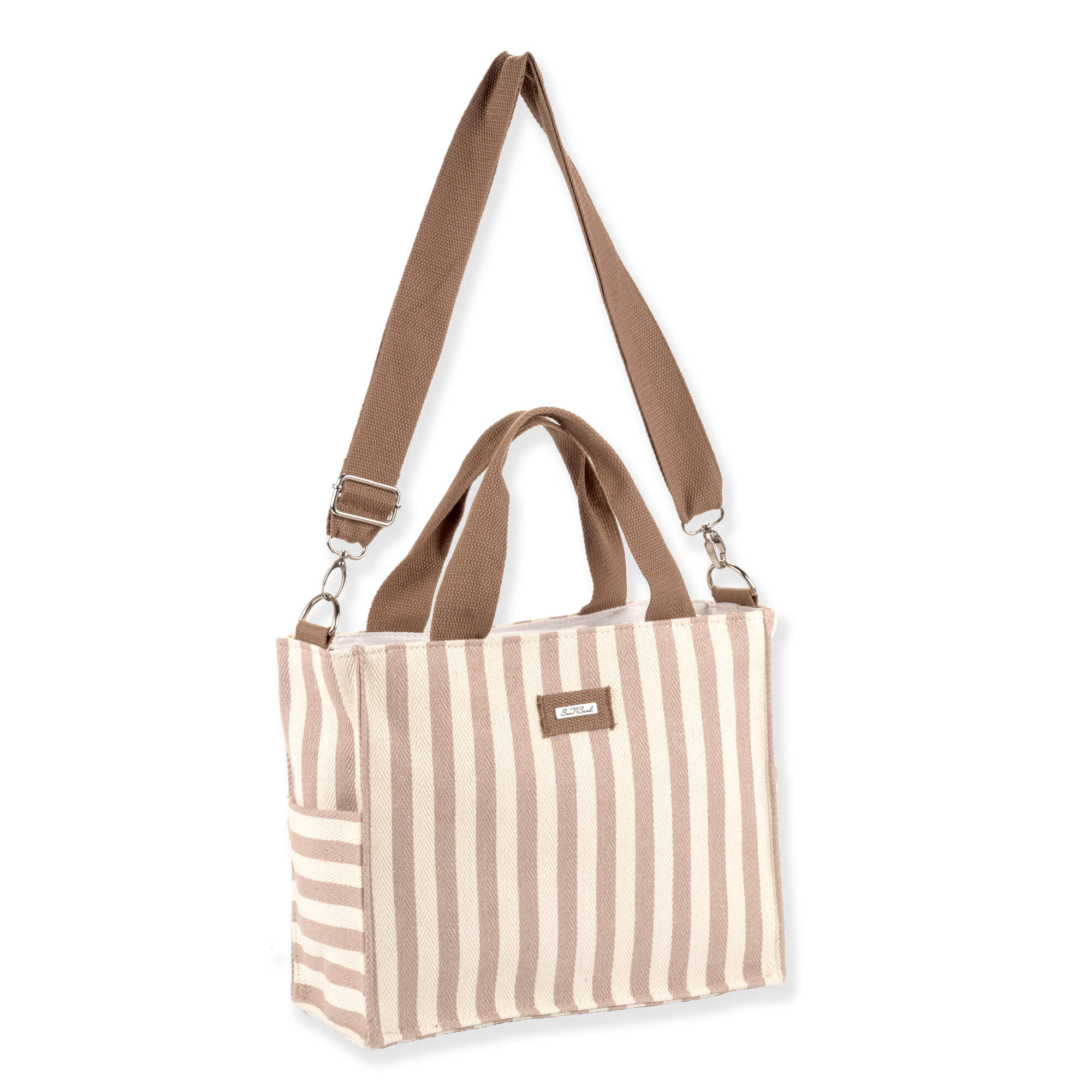 Three-quarter front view of Caribbean Joe tan striped canvas tote, brown woven straps, silver lobster clasps, and exterior side pockets.
