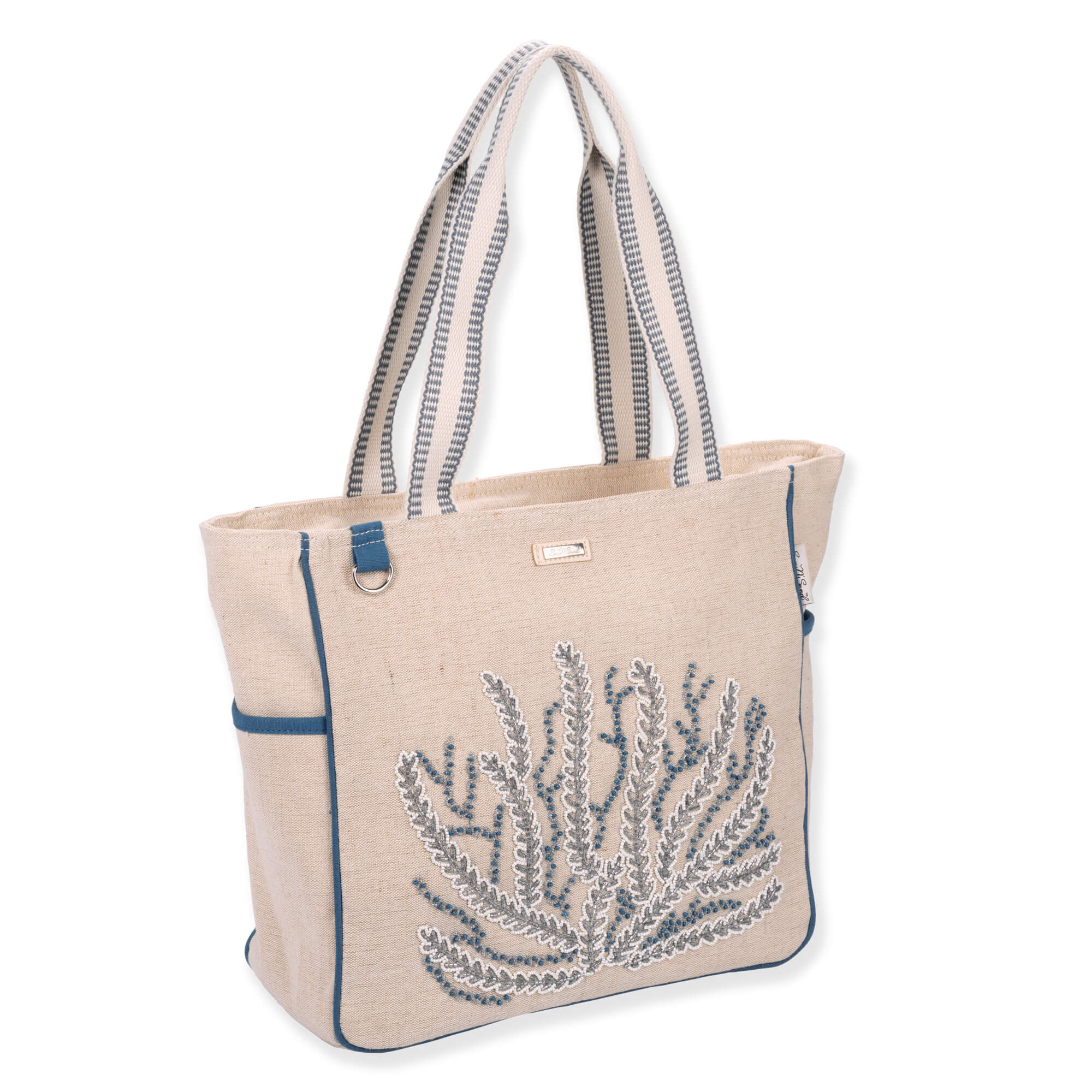 Three-quarter view of beige Sun 'N' Sand Beaded Coral shoulder tote featuring woven canvas texture, blue beaded coral, and metal D-ring.