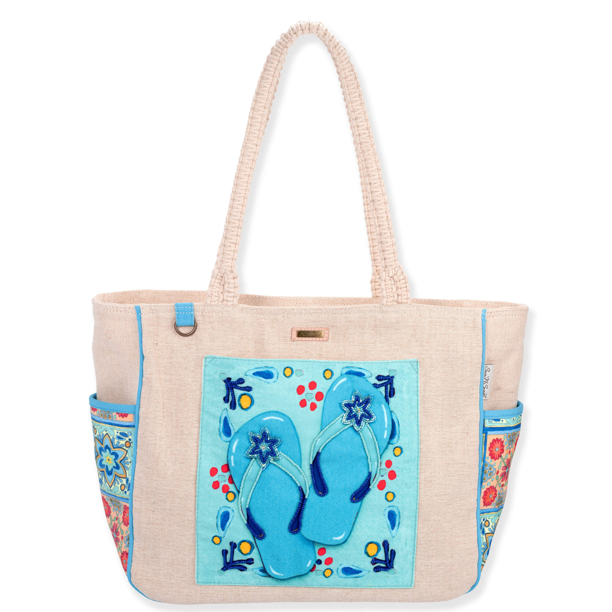 Front view of beige Sun 'N' Sand Andrea Tachiera shoulder tote featuring woven canvas, blue flip-flop applique, and braided handles.