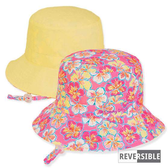 Three-quarter view of a reversible kids' bucket hat featuring a pink hibiscus floral print side and a solid yellow side.