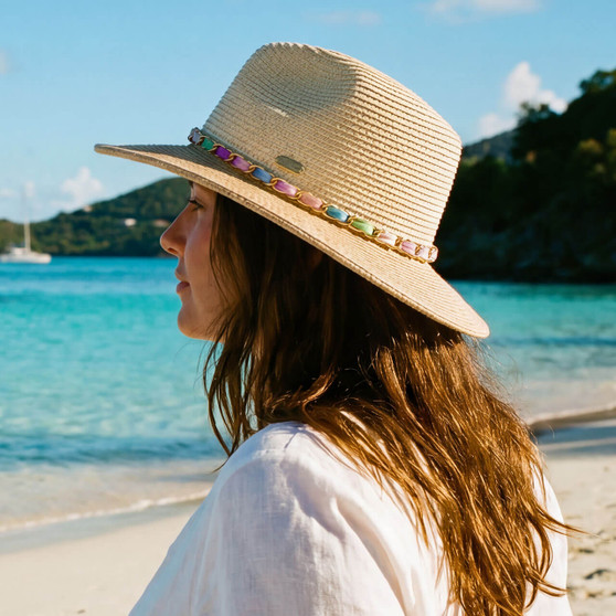Lifestyle portrait of the Sun N Sand HH3499 Women’s Safari Hat in natural-toned woven straw, featuring a navy blue and white striped hatband and a structured fedora crown for an adjustable fit and UPF 50+ sun protection.