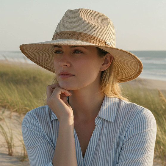 Lifestyle portrait of the Sun N Sand HH3506 Women’s Safari Hat in natural-toned woven straw, featuring an intricate open-work embroidered hatband and a structured crown for an adjustable fit and UPF 50+ sun protection.