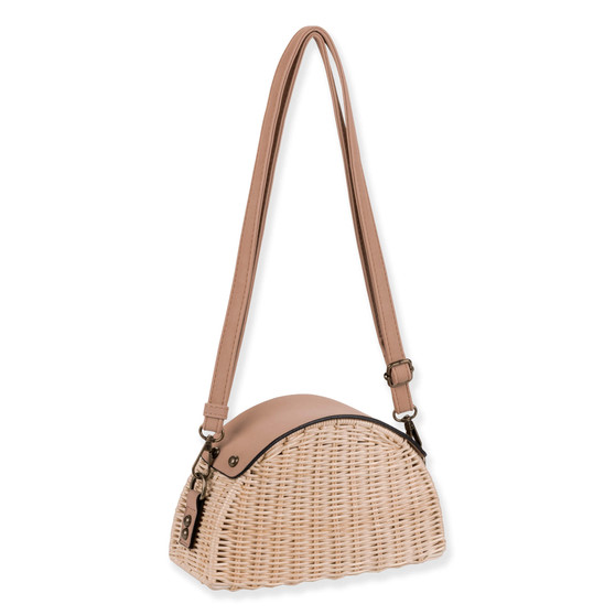 Side view of a half-moon cream wicker bag featuring a smooth tan leather top, adjustable shoulder strap, and antiqued bronze hardware.