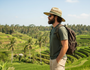 Side profile view of the HTT1056 Safari Hat in Natural Seagrass, featuring a vented crown and olive green chin strap for breathable outdoor sun protection.