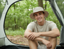Lifestyle front view of the Sun N Sand HTT1084 men's safari sun hat in Khaki, featuring a wide structured brim with side snaps and an adjustable toggle chin strap for reliable sun protection during camping and hiking.