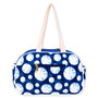 Navy blue canvas cosmetic pouch with white seashell dot pattern, rear zippered pocket, rounded silhouette, rope handle, back view shown