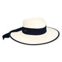 Three-quarter view of a white woven straw boater hat featuring a wide navy blue ribbon band and a matching navy-edged brim.
