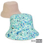 Front view of reversible bucket hat showing plain beige side and blue‑green tropical palm‑leaf patterned side with small reversible label.