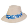 Three-quarter view of a tan linen fedora featuring a blue and white tropical print band and side metal grommets.