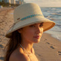 Front angled view of the Sun N Sand tapered bucket hat in natural straw, featuring slim crown shape and adjustable UPF‑protection design.