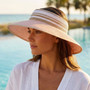 Lifestyle portrait of the Sun N Sand HH3555 Women’s Packable Rollup Visor in a black and white woven straw pattern, featuring an adjustable hook and loop closure and a wide, downturned brim for a custom fit and UPF 50+ sun protection.