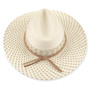 Three-quarter profile view of a cream-colored woven straw safari hat featuring a pinched crown, geometric-patterned band, and gold metal logo.