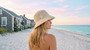 Front angled view of the Sun N Sand bucket hat in natural straw, featuring decorative starfish accent and adjustable design for UPF protection