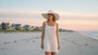Lifestyle portrait of the Sun N Sand HH3507 Women’s Safari Hat in white woven straw, featuring a wide, dramatic floppy brim and a structured crown for an adjustable fit and UPF 50+ sun protection.
