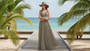 Lifestyle profile portrait of the Sun N Sand HH3625 Women’s Gambler Hat in a dark charcoal and white patterned weave, featuring a matching hatband with a side metallic brand plate and a wide, structured flat brim with a flat crown for an adjustable fit