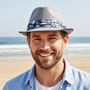 Lifestyle close-up front view of the Sun N Sand HTT1322 men's straw fedora in Grey, featuring a blue floral print fabric hatband and a classic pinched crown for refined beach style and lightweight sun protection while enjoying the coast.
