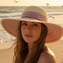 Front angled view of the Sun N Sand floppy hat in soft paper braid, featuring striped accent band and adjustable UPF‑protection design
