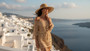 Lifestyle profile portrait of the Sun N Sand HH3634 Women’s Floppy Hat in a natural-toned woven fabric, featuring a contrasting black ribbon hatband with a side metallic brand plate and a wide, structured floppy brim for an adjustable fit and UPF 50+ sun
