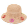 Three-quarter profile view of a tan crocheted straw bucket hat featuring a rounded crown, rope trim, and colorful floral embroidery.