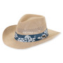 Three-quarter view of a natural straw western hat featuring a vented crown, upturned brim, and a blue floral fabric band.