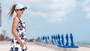 Lifestyle profile portrait of the Sun N Sand HH3591 Women’s Ball Cap in a clean white technical fabric, featuring a specialized high ponytail-bun opening and laser-perforated side panels for maximum airflow with an adjustable hook and loop closure for a