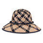 Three-quarter profile view of a toasted-brown woven straw western hat featuring a pinched crown, star-studded faux-leather band, and curved brim.