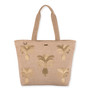 Front view of a rectangular beige woven jute tote featuring gold embroidered pineapple graphics, wide handles, and metal hardware.