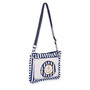 side view of a rectangular white crossbody bag featuring a navy striped anchor emblem, matching striped trim, and metal hardware.