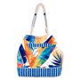 back  view of a bucket-shaped tote bag featuring colorful tropical leaves, a blue striped base, and textured rope handles.