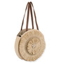 Side Front view of round woven straw tote with radiating sunburst pattern, medium brown leather straps, and structured natural design highlighting artisanal texture.