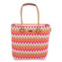 Front view of colorful zigzag tote with pink, orange, white, beige pattern, tan handles with circular accents, and small top brand tag.