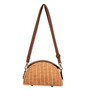 Front view of a half-moon honey wicker bag featuring a dark brown leather top, adjustable shoulder strap, and antiqued bronze hardware.
