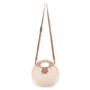 Front view of a circular woven straw bag featuring tan leather-wrapped handles, an adjustable crossbody strap, and antiqued gold-tone hardware