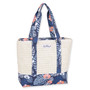Side view of cream woven straw Sun N Sand tote featuring blue tropical monstera leaf canvas trim and matching straps.