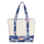 Rear view of cream woven straw Sun N Sand tote featuring blue tropical monstera leaf canvas trim and matching straps.
