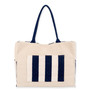 Rear view of Sun 'N' Sand cream canvas tote, featuring a navy striped trolley sleeve, navy woven straps, and side pockets.