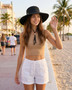 Female wearing a black floppy hat featuring Chin Cord, Packable, Adjustable, UPF 50+.