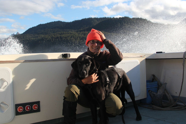 Dog and person on boat