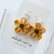 Hollow floral hoops available in either daisies or black eyed susans!
Earrings are finished with 20mm 18k gold plated hoops.