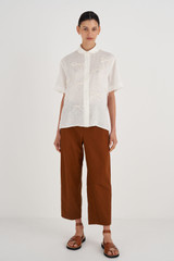 Profile view of model wearing the Oroton Bow Detail Shirt in Antique White and 100% Linen for Women