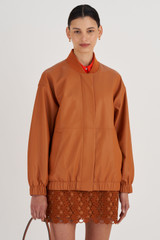 Profile view of model wearing the Oroton Leather Bomber in Tan and 100% Leather for Women