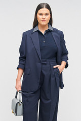 Profile view of model wearing the Oroton Single Breasted Blazer in North Sea and 98%  wool, 2% elastane for Women . IP:8